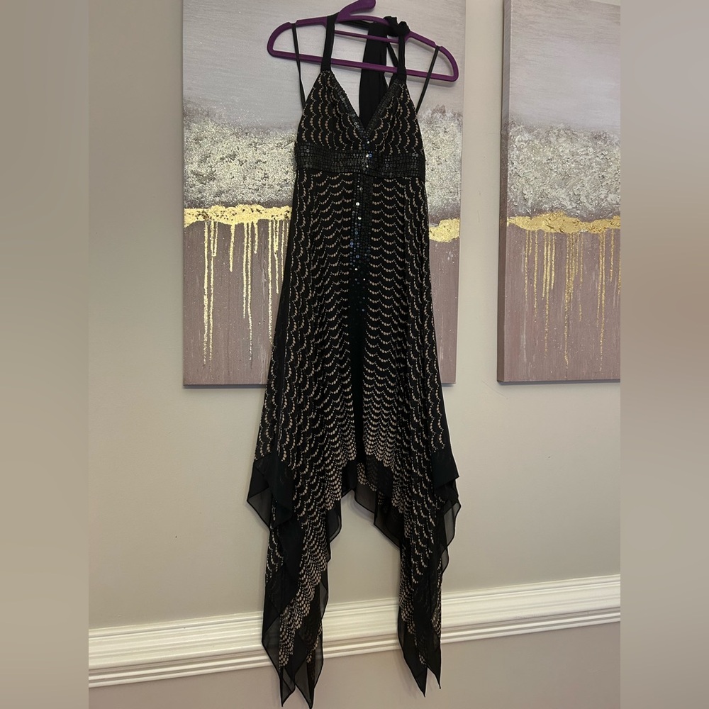 BCBGMaxAzria Black and Gold Asymmetrical Cocktail Dress
New with out Tag .